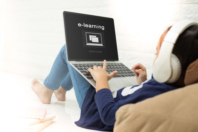 asian child asian child using laptop with inscription on screen e-learning . Online education,e-learning.